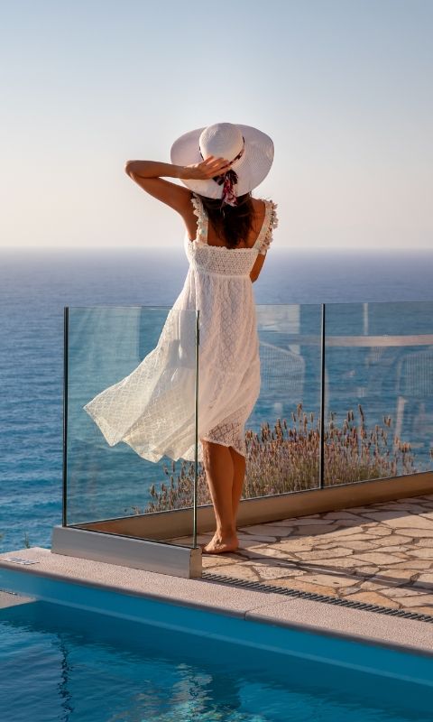 a person on a balcony looking out to sea