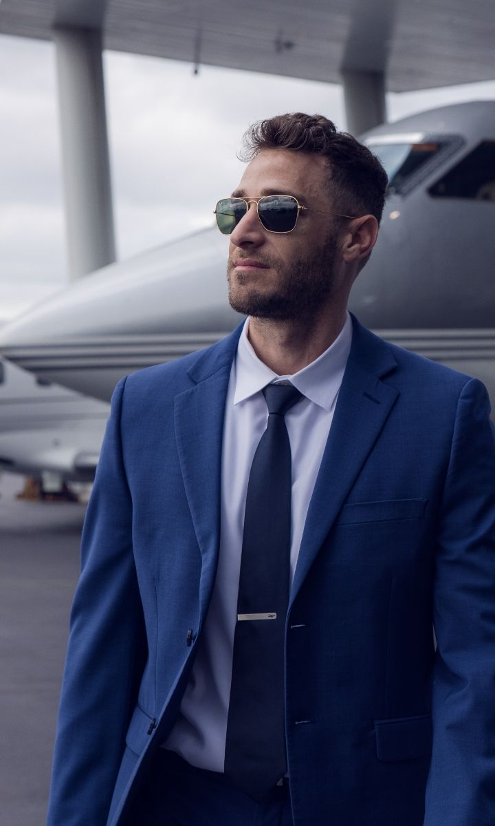 a well-dressed person getting on a plane